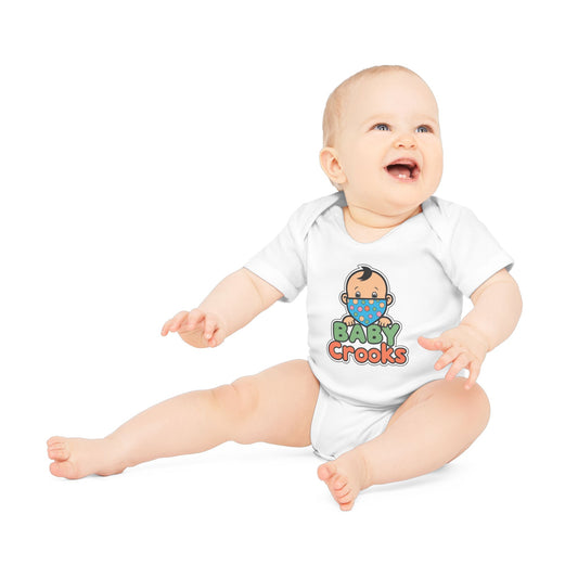 Baby wearing a white onesie with 'Baby Crooks' print on a white background